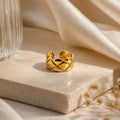Gold quilted ring on marble with silk, anti-tarnish luxury jewelry for women