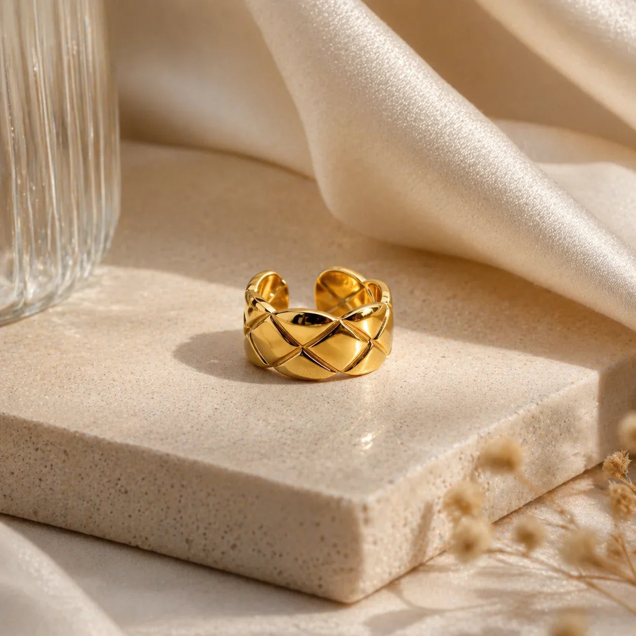 Gold quilted ring on marble with silk, anti-tarnish luxury jewelry for women