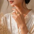 Gold textured ring on woman's hand, elegant everyday luxury jewelry for women