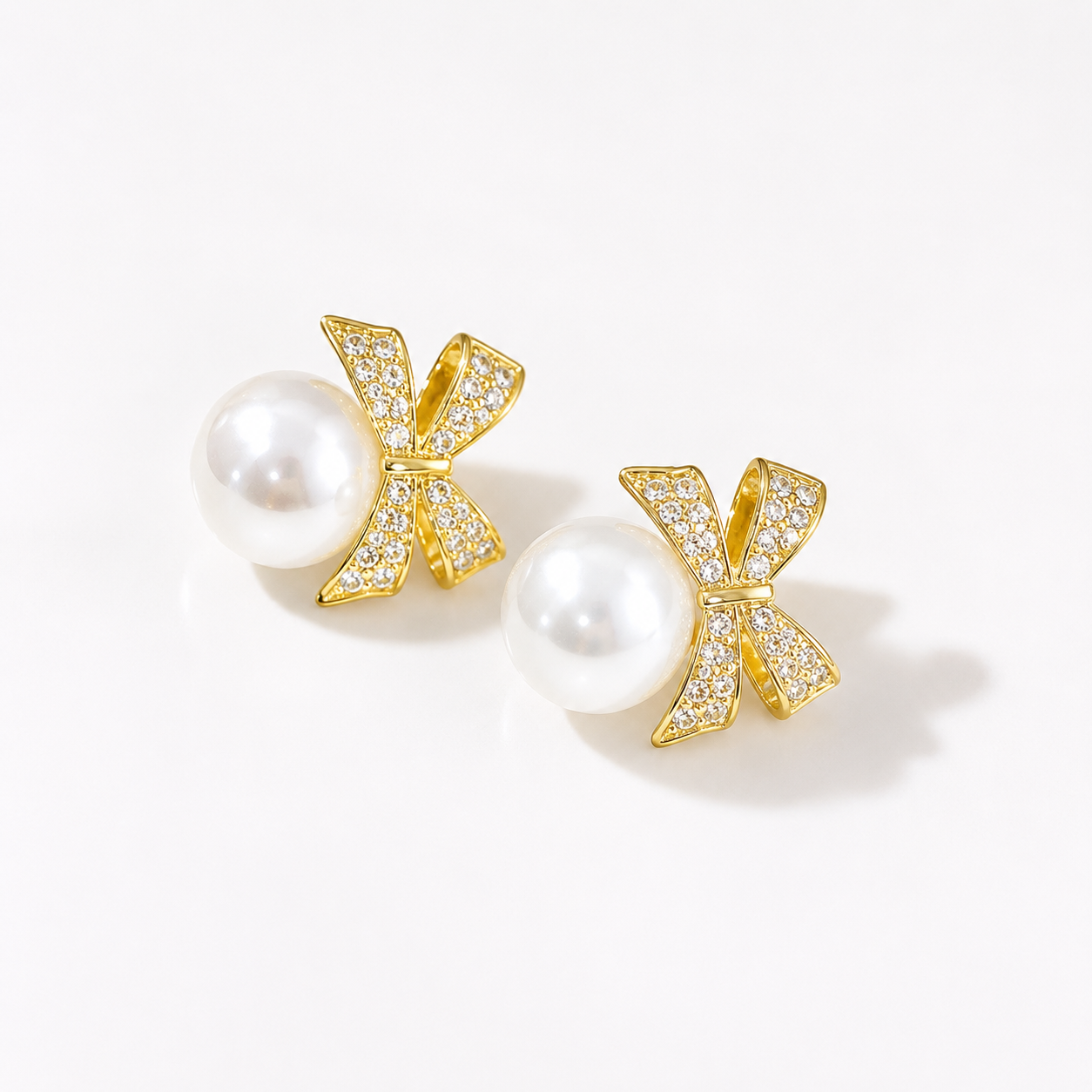 Gold bow pearl earrings with crystal accents, elegant anti-tarnish jewelry for women