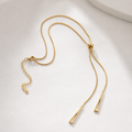 Gold adjustable lariat necklace with geometric drop pendants, anti-tarnish finish for everyday luxury