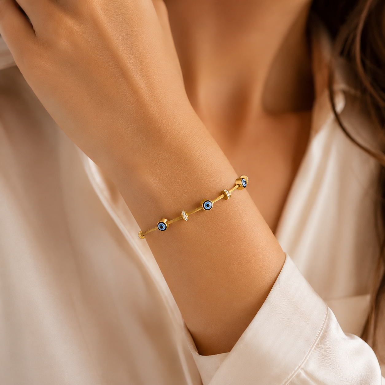 Gold evil eye bracelet with blue eyes and crystals, elegant anti-tarnish jewelry for women