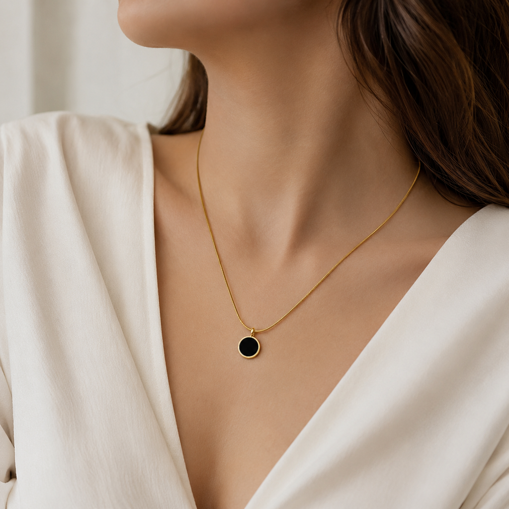 Gold chain necklace with black circular pendant, elegant everyday luxury jewelry for women