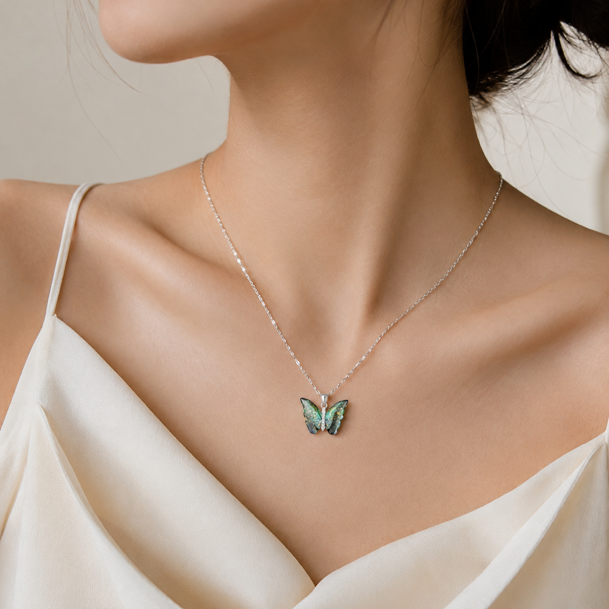 Elegant butterfly pendant necklace with iridescent green wings, perfect for everyday luxury jewelry.