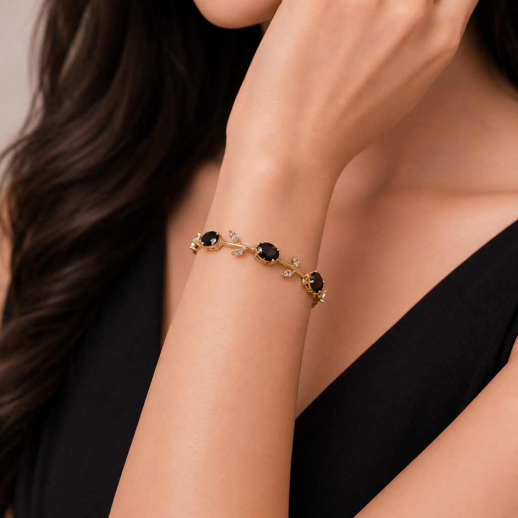 Elegant gold bracelet with black stones and diamond accents, perfect for everyday luxury.