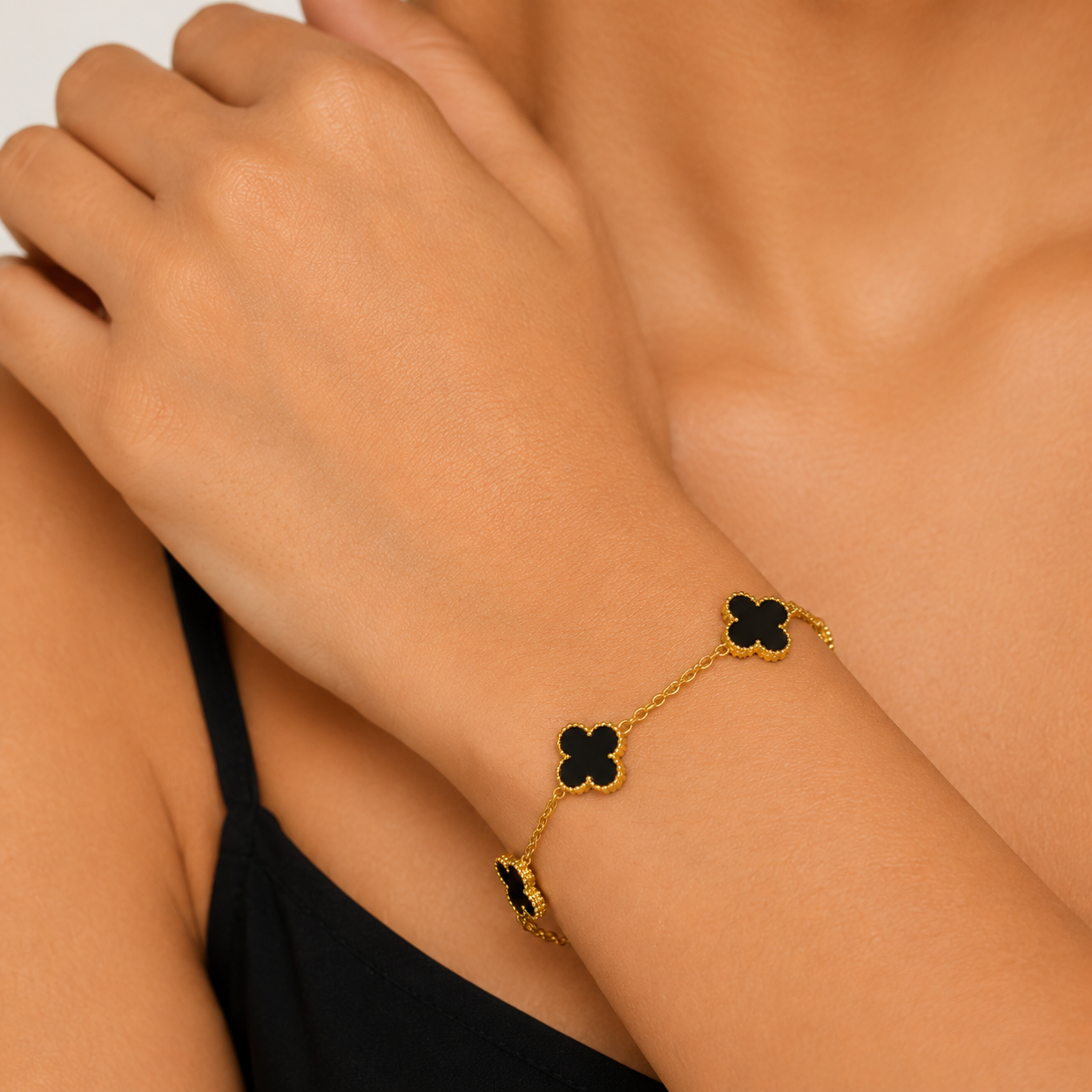 Gold chain bracelet with black clover charms, elegant everyday luxury jewelry for women