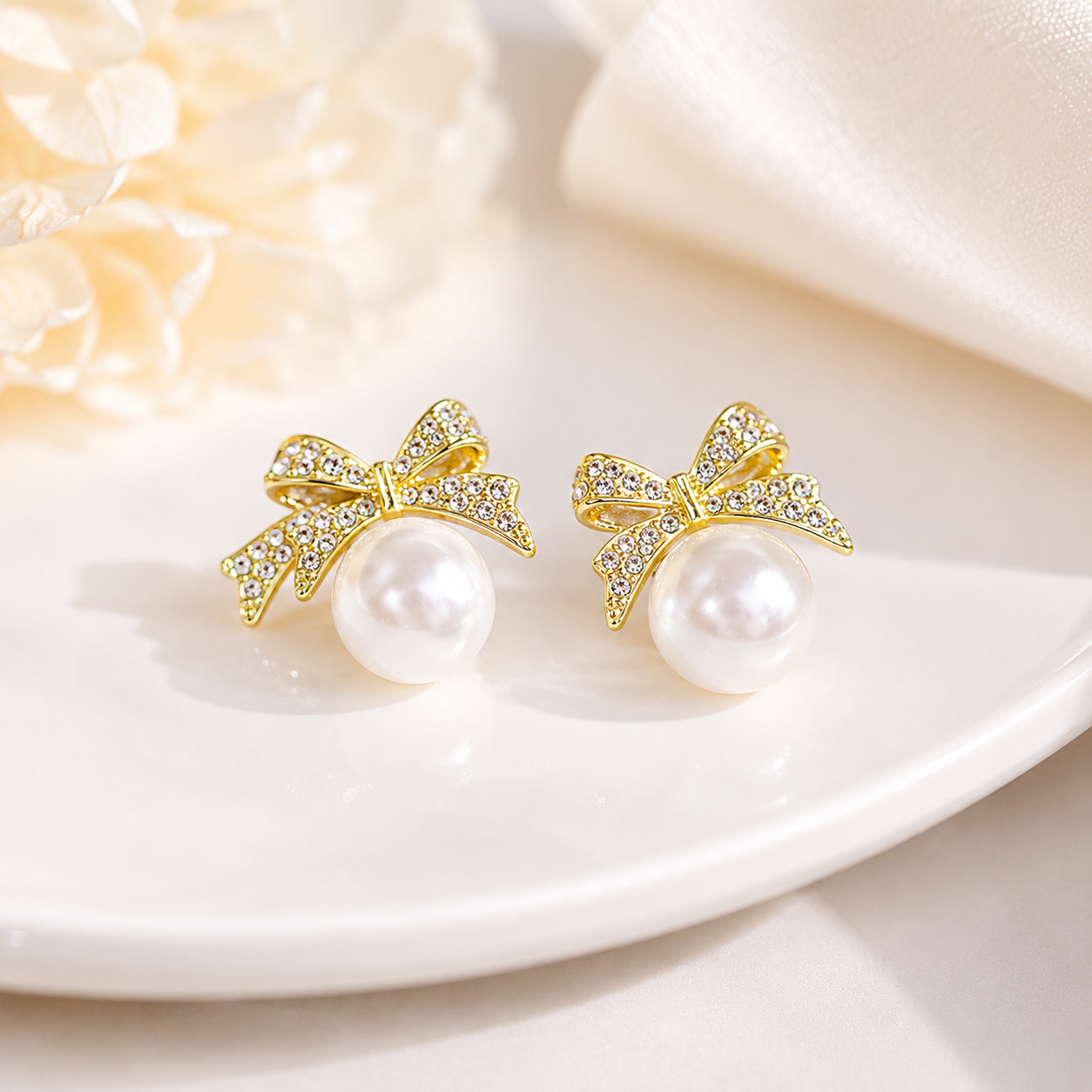 Gold bow pearl stud earrings with crystal accents, elegant anti-tarnish jewelry for women