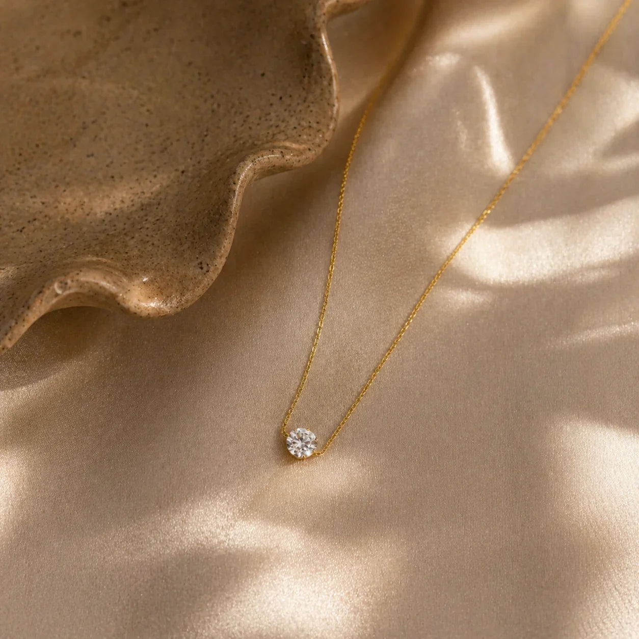 Delicate gold necklace with solitaire diamond pendant on satin, anti-tarnish luxury jewelry for women