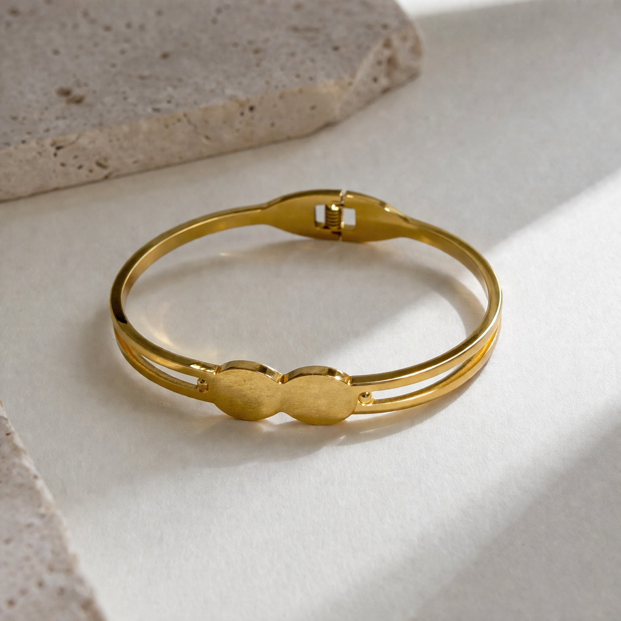 Elegant gold bangle with double oval design, anti-tarnish finish, perfect for everyday luxury style.
