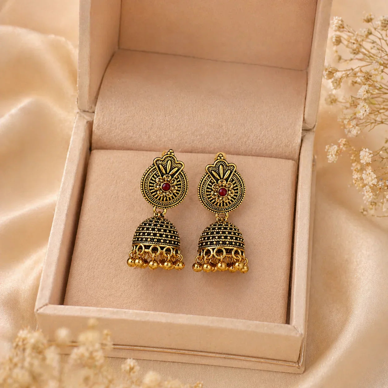Gold jhumka earrings with red stone, anti-tarnish design, elegant traditional jewelry for women