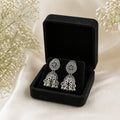 Anti-tarnish silver jhumka earrings in black velvet box with white flowers, elegant women's jewelry