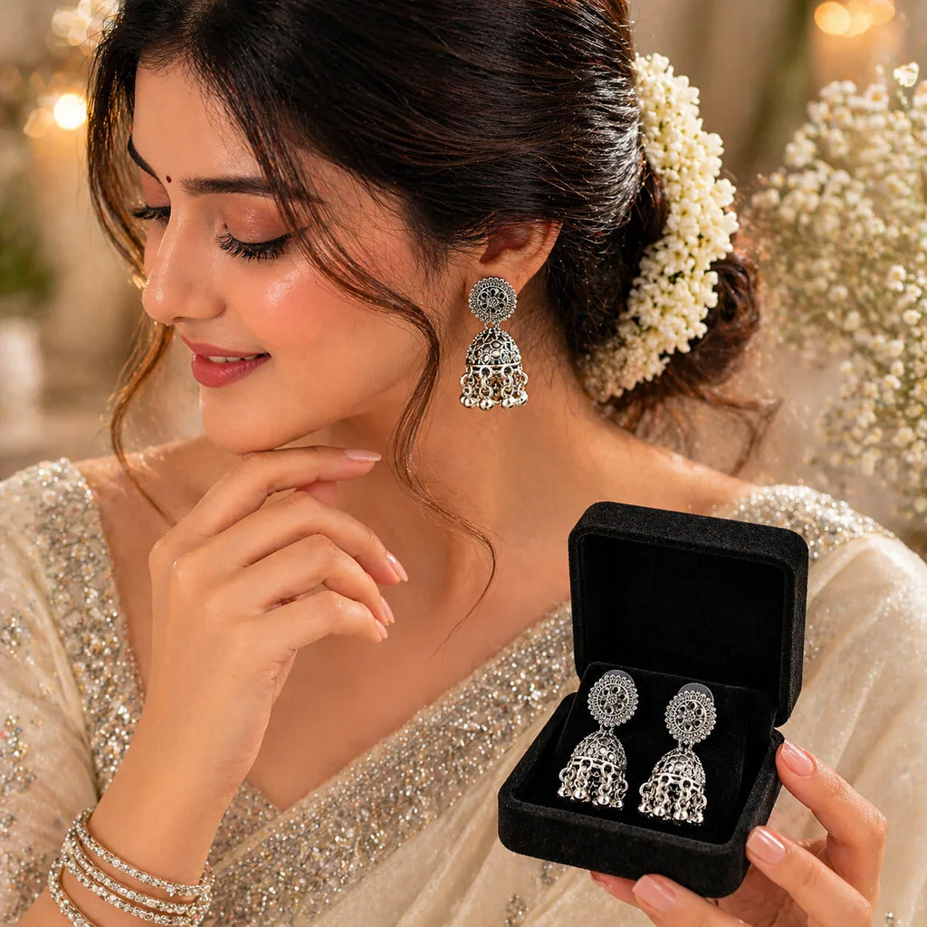 Elegant silver jhumka earrings with intricate filigree design, perfect for festive wear and everyday luxury.