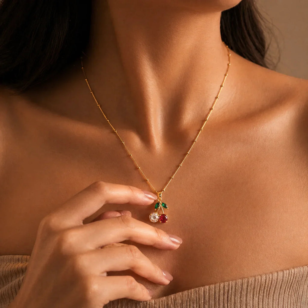 Gold cherry pendant necklace with red and green gemstones, elegant women's jewelry