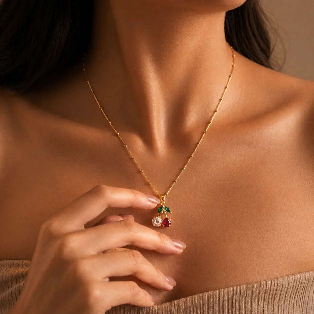 Gold cherry pendant necklace with red and green gemstones, elegant women's jewelry