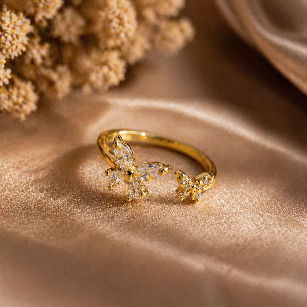 Gold butterfly ring with clear gemstones, elegant anti-tarnish jewelry for women, styled on soft fabric