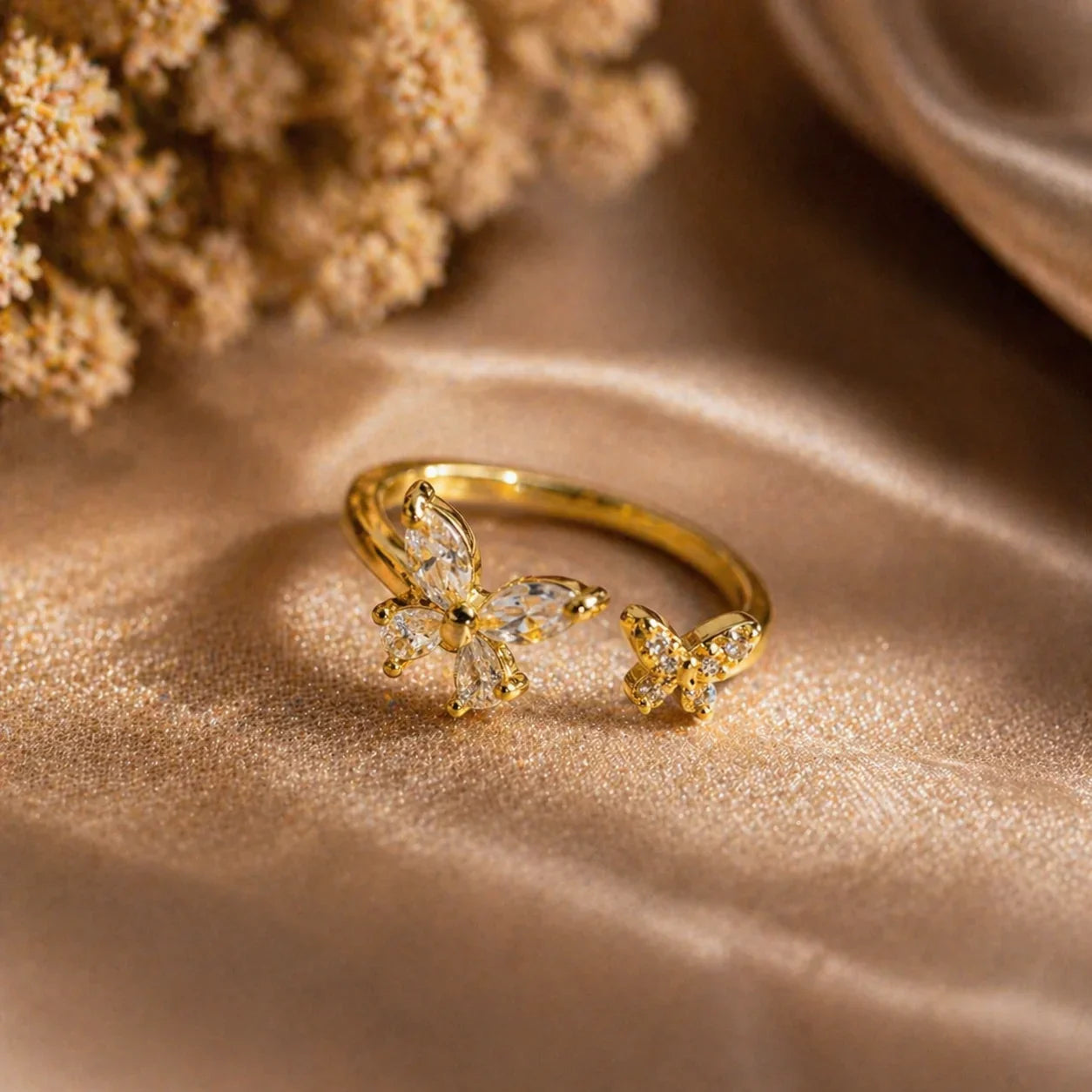 Gold butterfly ring with clear gemstones, elegant anti-tarnish jewelry for women, styled on soft fabric