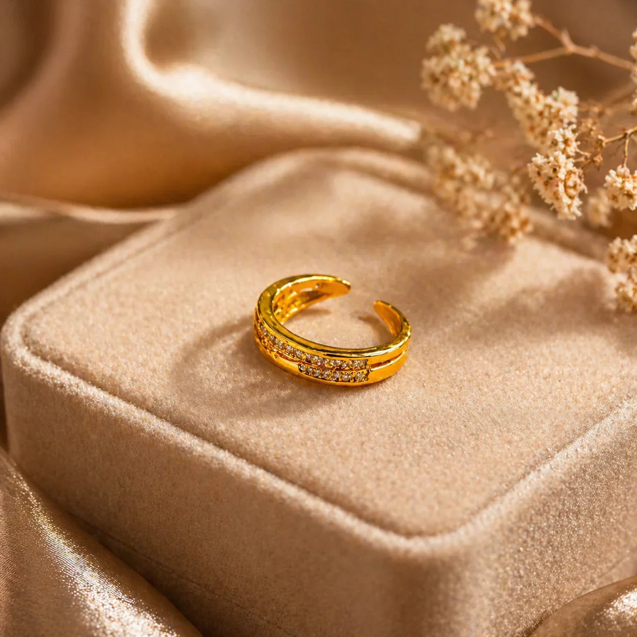 Gold crescent ring with sparkling stones on velvet box, elegant anti-tarnish jewelry for women