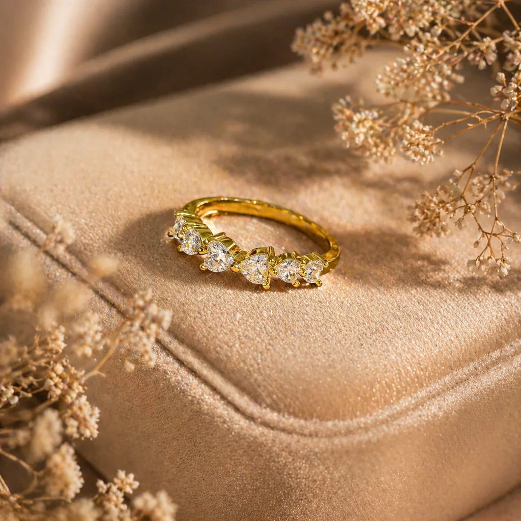 Gold ring with clear stones on velvet, dried flowers nearby — elegant anti-tarnish jewelry for women