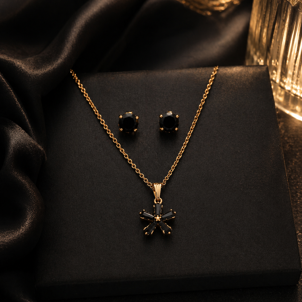 Elegant gold necklace and stud earrings with black gemstones, perfect for everyday luxury jewelry for women