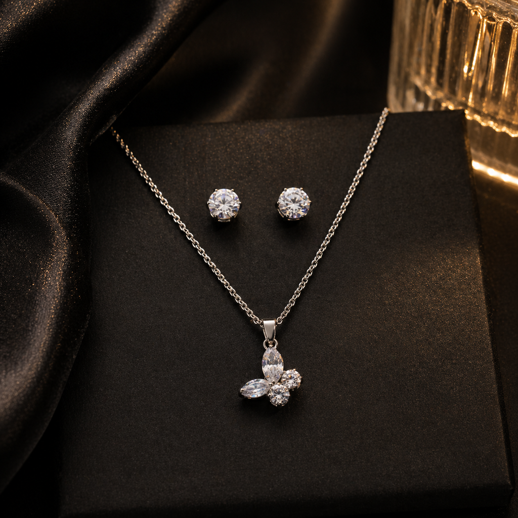 Elegant silver necklace and stud earrings set with sparkling clear stones, perfect for everyday luxury.