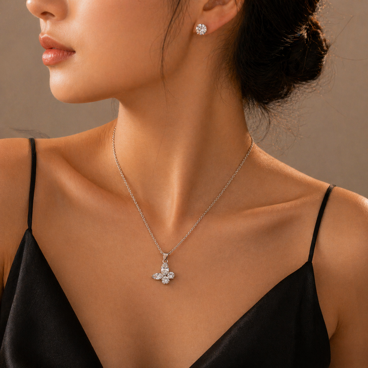 Elegant diamond butterfly pendant necklace with matching stud earrings, perfect for everyday luxury.