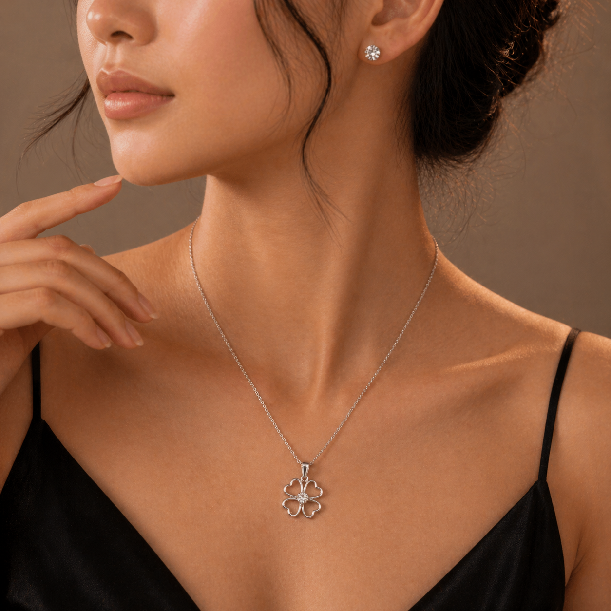 Elegant silver flower pendant necklace with diamond accents, paired with stud earrings for everyday luxury.