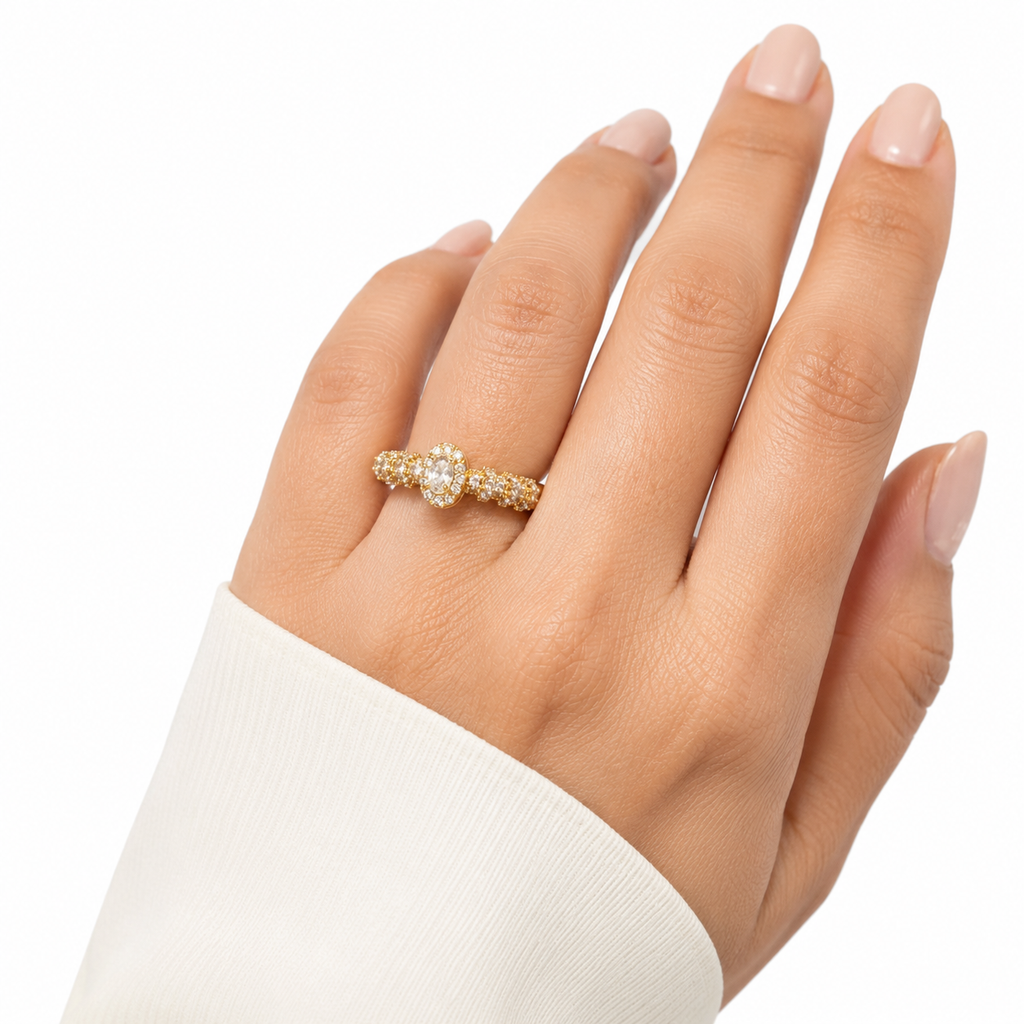 Elegant gold ring with diamond halo and pave band, worn on woman's hand, anti-tarnish luxury jewelry