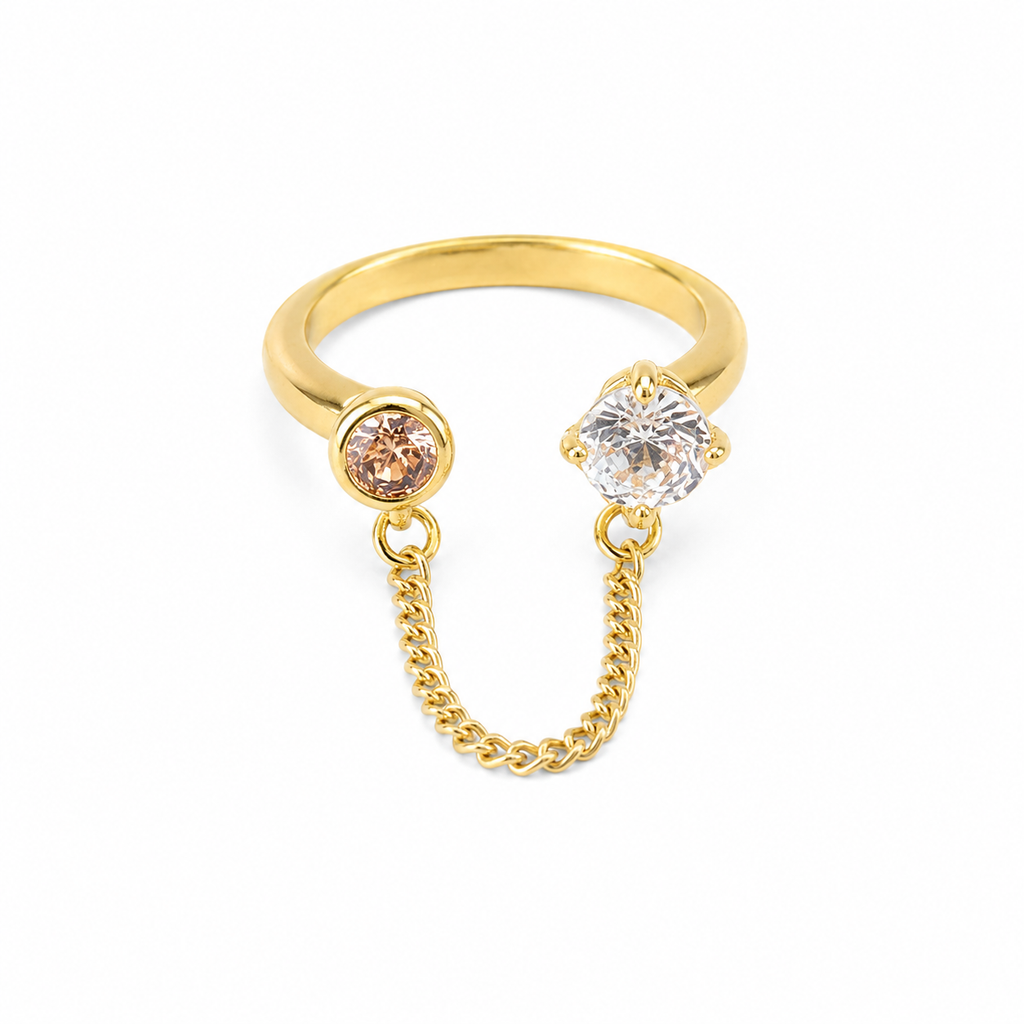 Gold ring with clear and pink gemstones connected by delicate chain, anti-tarnish luxury jewelry