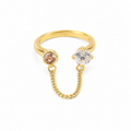 Gold ring with clear and pink gemstones connected by delicate chain, anti-tarnish luxury jewelry