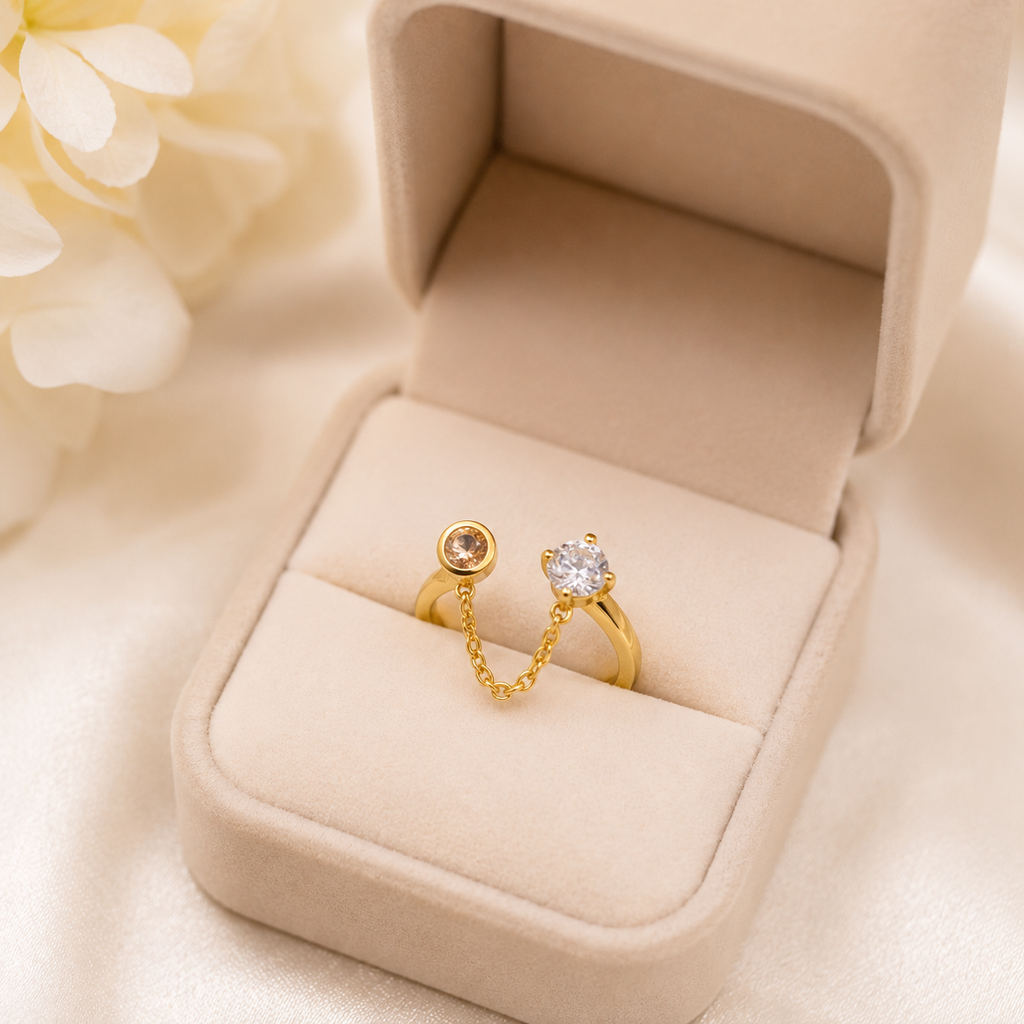 Gold chain link ring with clear and champagne stones in velvet box, elegant women's jewelry
