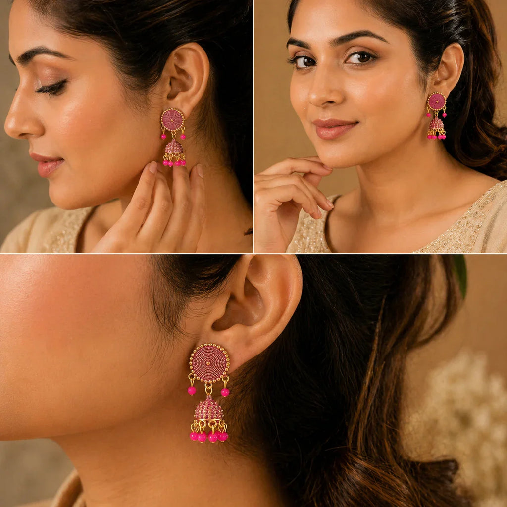 Pink jhumka earrings with gold detailing, worn by woman in traditional attire, anti-tarnish jewelry